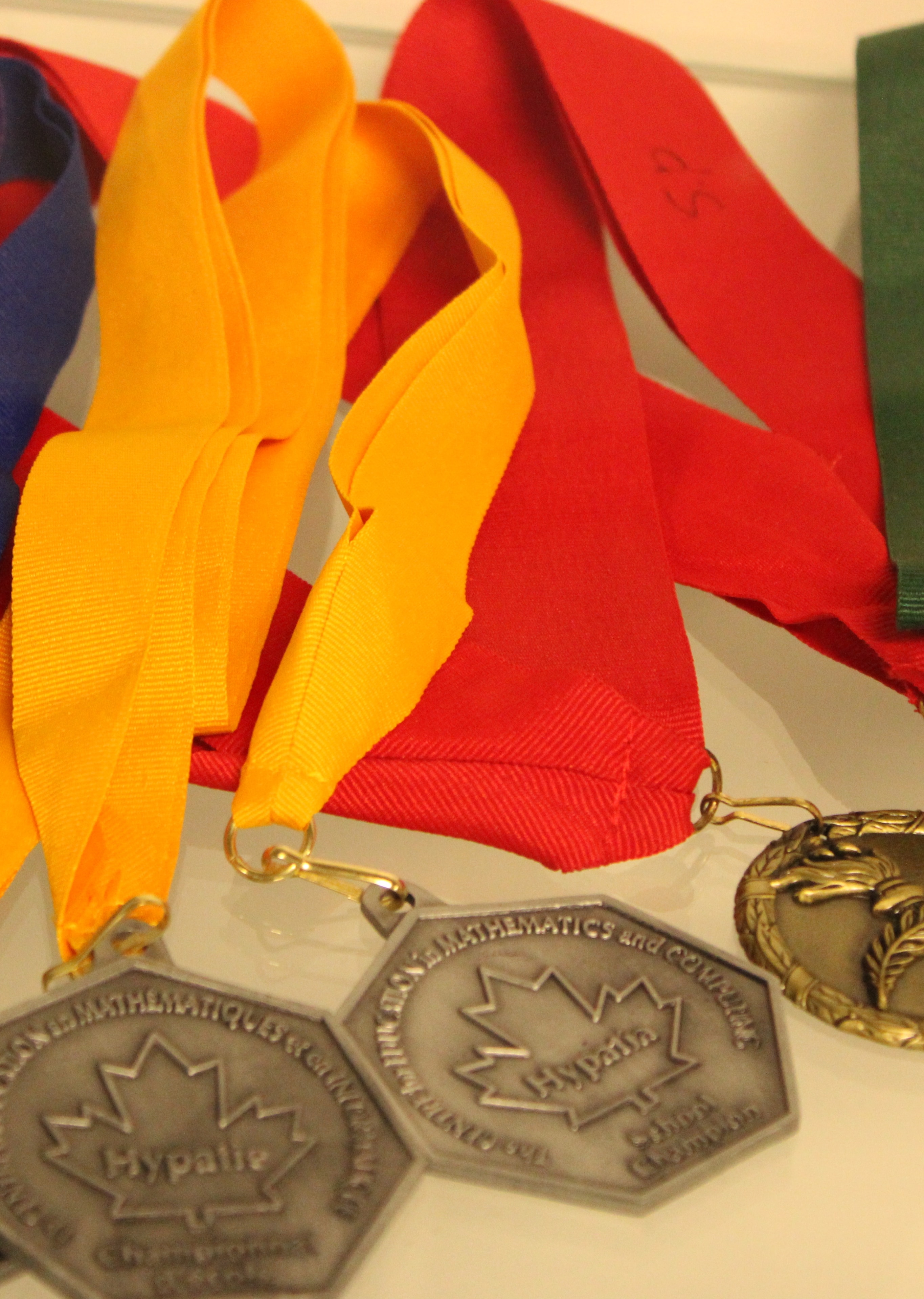 Competition medals with colorful ribbons