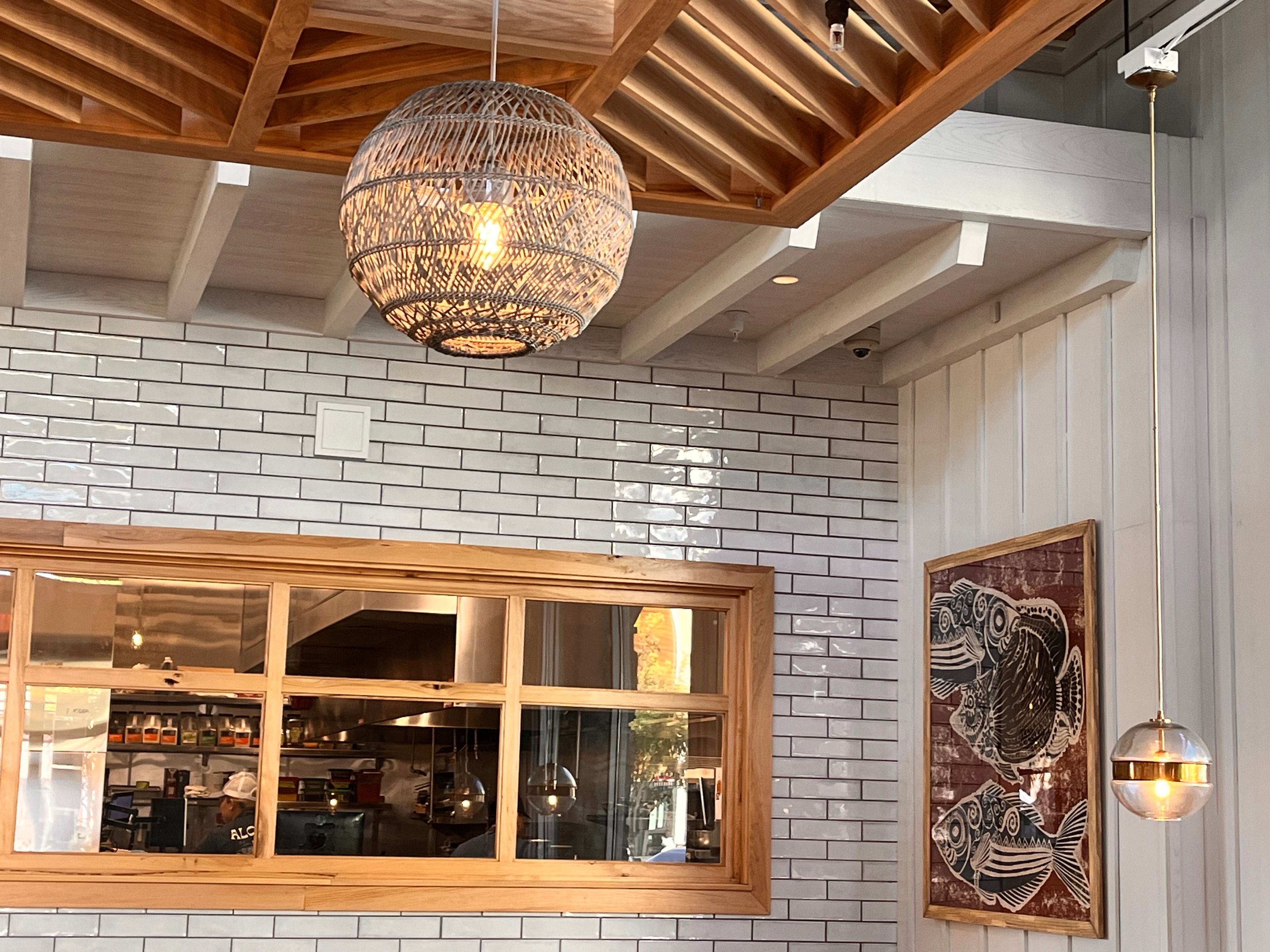 Restaurant with wicker pendant and fish artwork