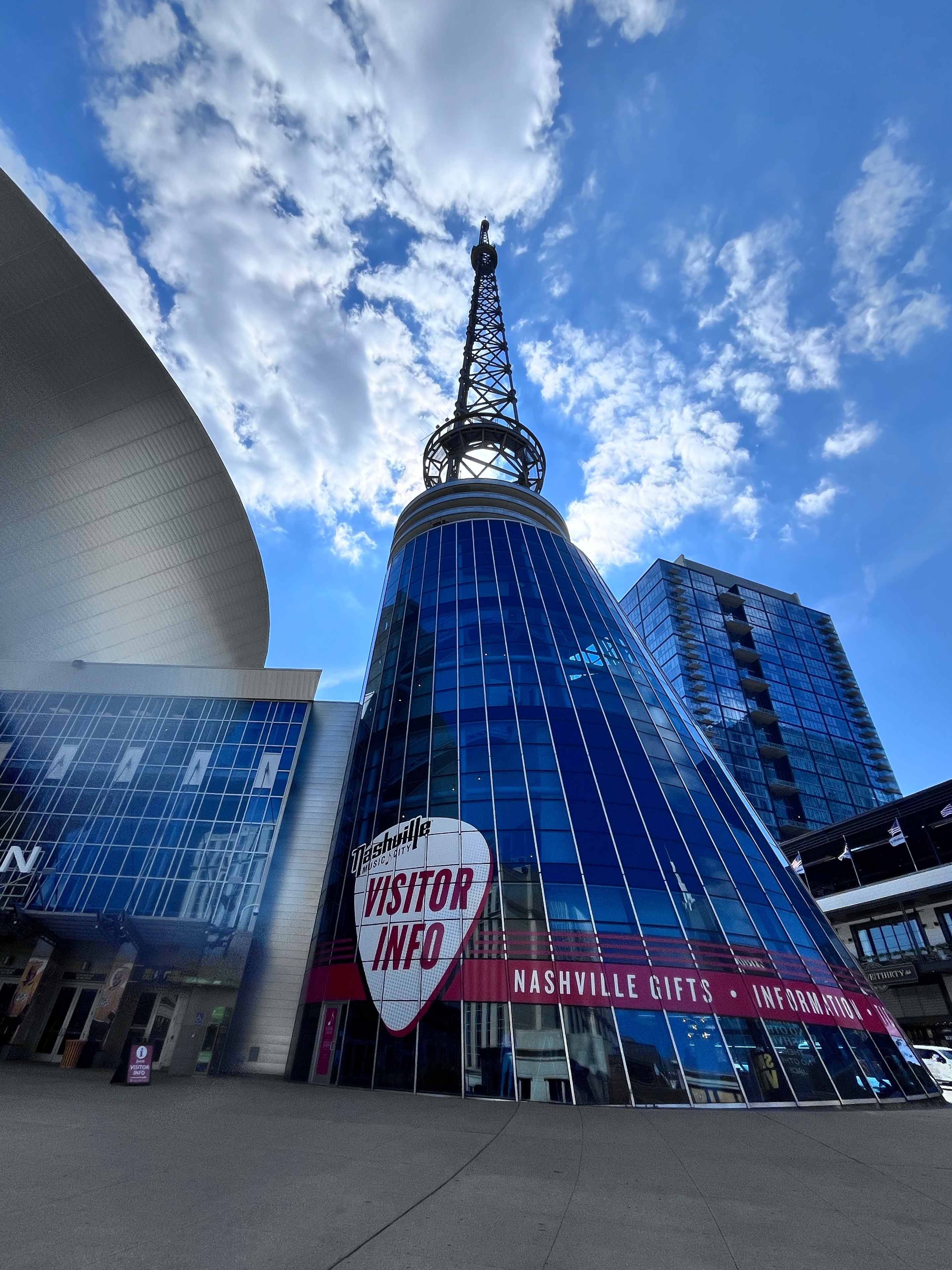 Nashville BT Tower rising into blue sky with visitor info signage