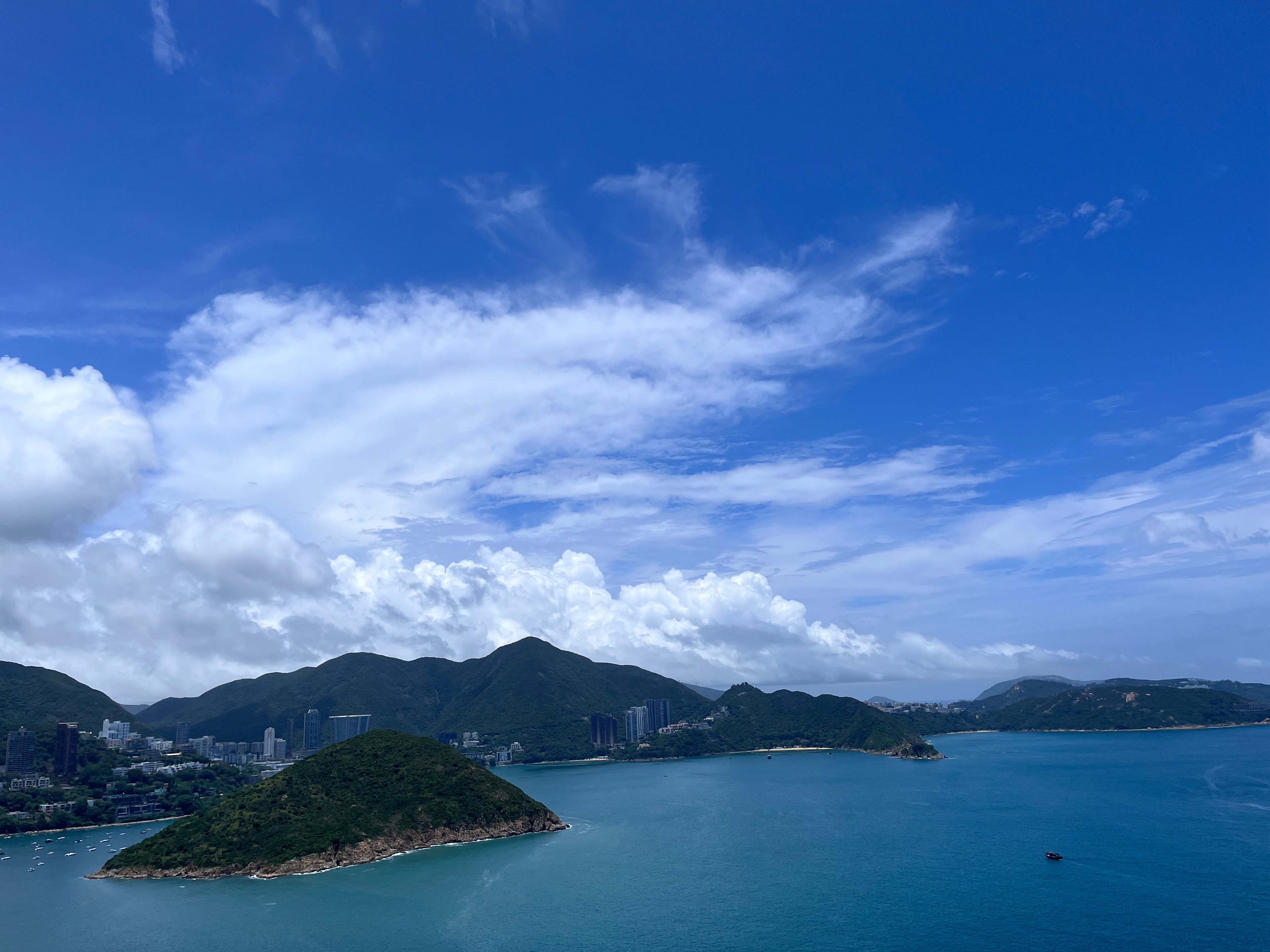 Hong Kong coastal bay with green islands and turquoise water under vivid blue sky